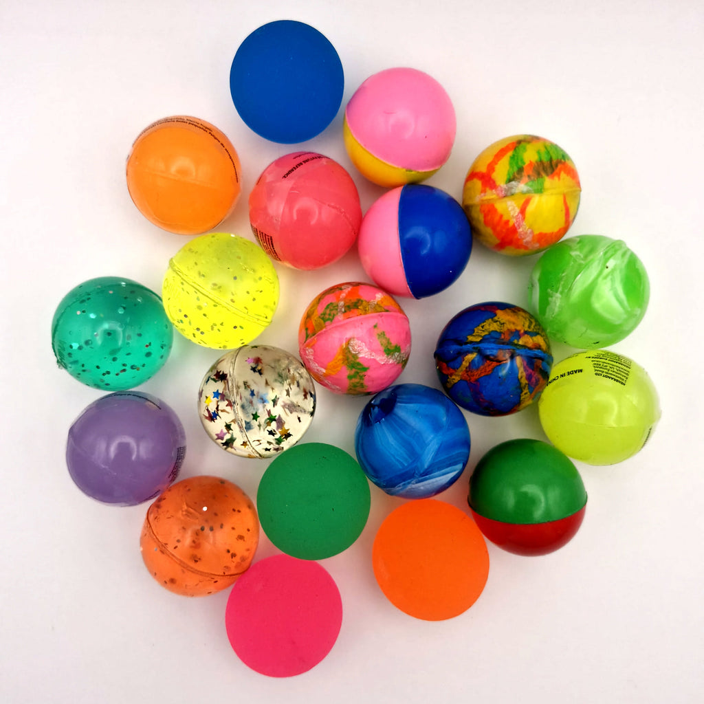 A collection of children's bouncy balls, on a white background.