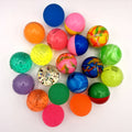 A collection of children's bouncy balls, on a white background.