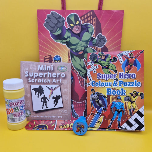 Superhero-themed children's colouring book, scratch art kit, and toy on a yellow background