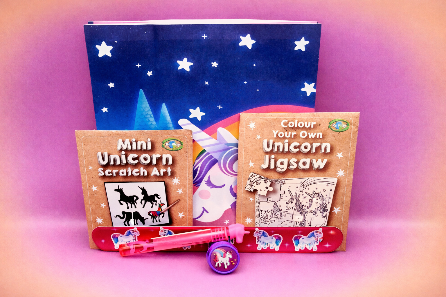 Unicorn-themed children's activities set with books and a scratch art kit on a gradient background