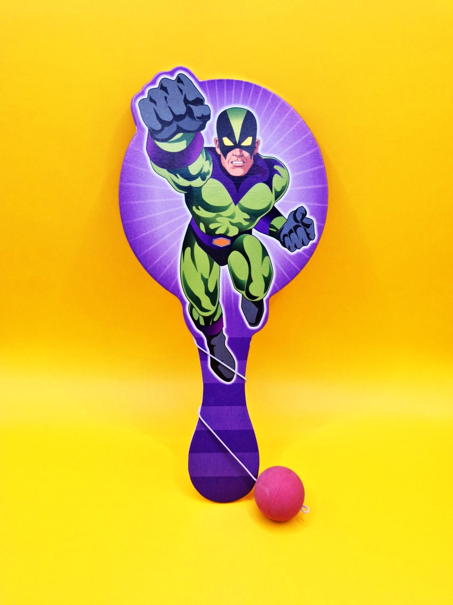 Superhero-themed paddle with a pink ball on a yellow background