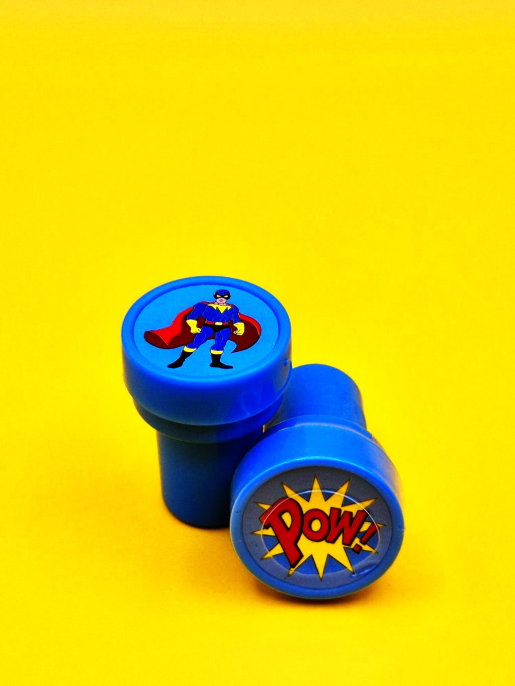 Superhero-themed blue stamp on a yellow background