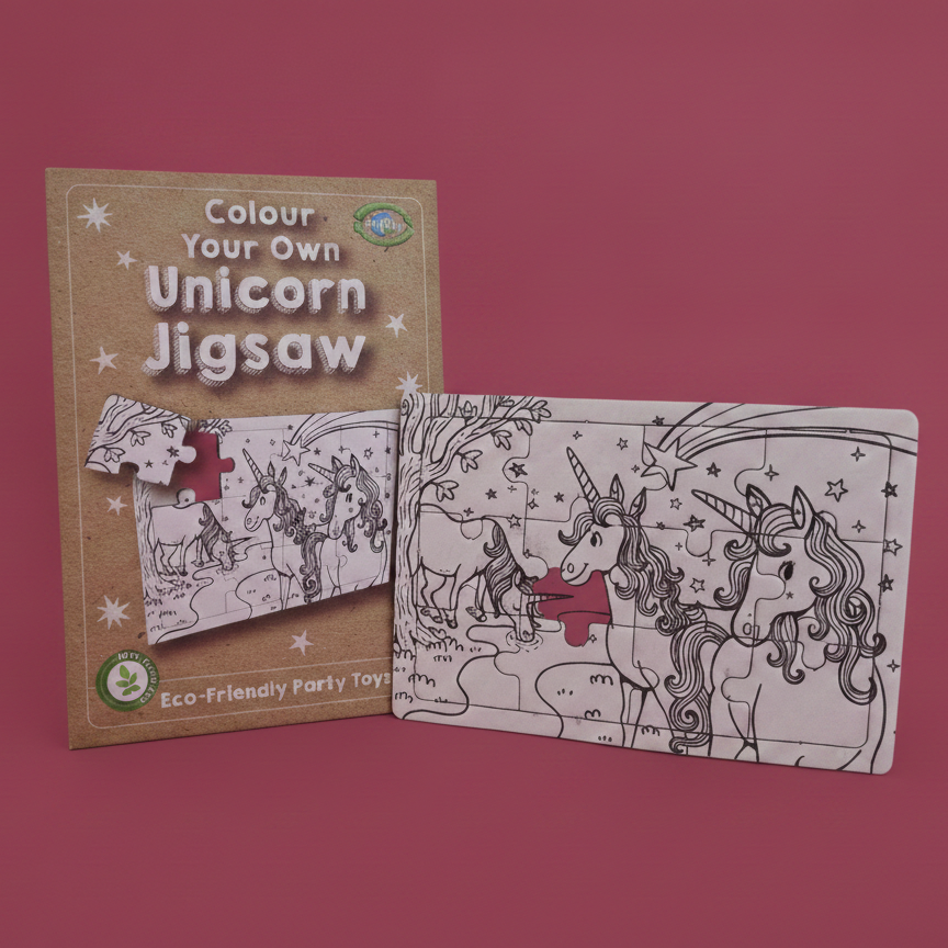 A children's unicorn jigsaw puzzle set shown on a pink background, with the tan packaging card behind a partially assembled black-and-white line-art puzzle that has a small red accent piece.